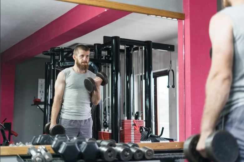Athlete training with dumbbells